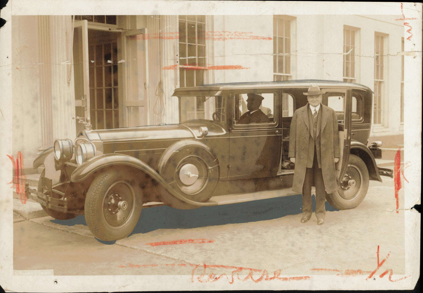 Herbert Hoover stands in front of Rolls Royce